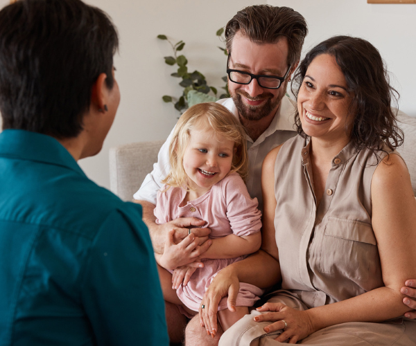 family with baby on couch