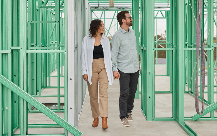 couple reviewing house frame